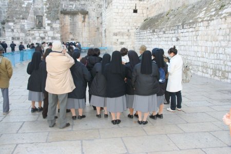 Nonnen staan voor de ingang van de geboorte kerk in Bethlehem